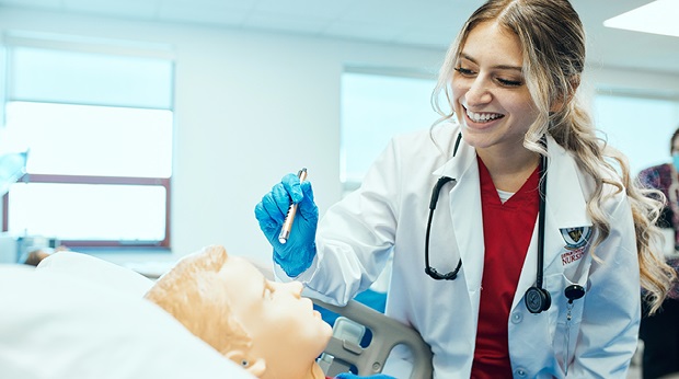 A La Roche University nursing student performs an assessment on a mannequin in the clinical simulation center.